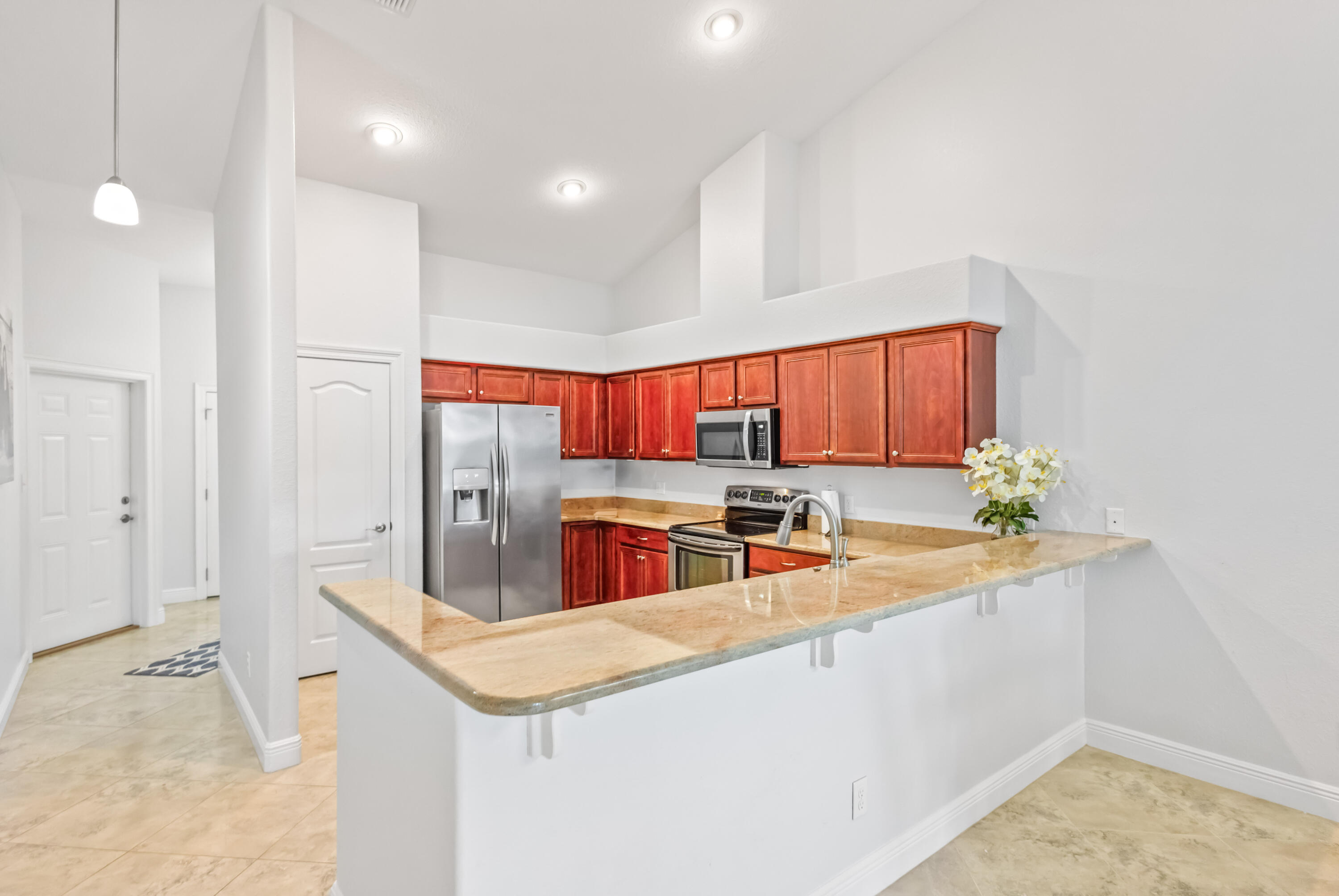 4248 Jade Loop Destin, FL 32541 - Photo 8 of 46 a kitchen with stainless steel appliances granite countertop a sink a stove and a refrigerator