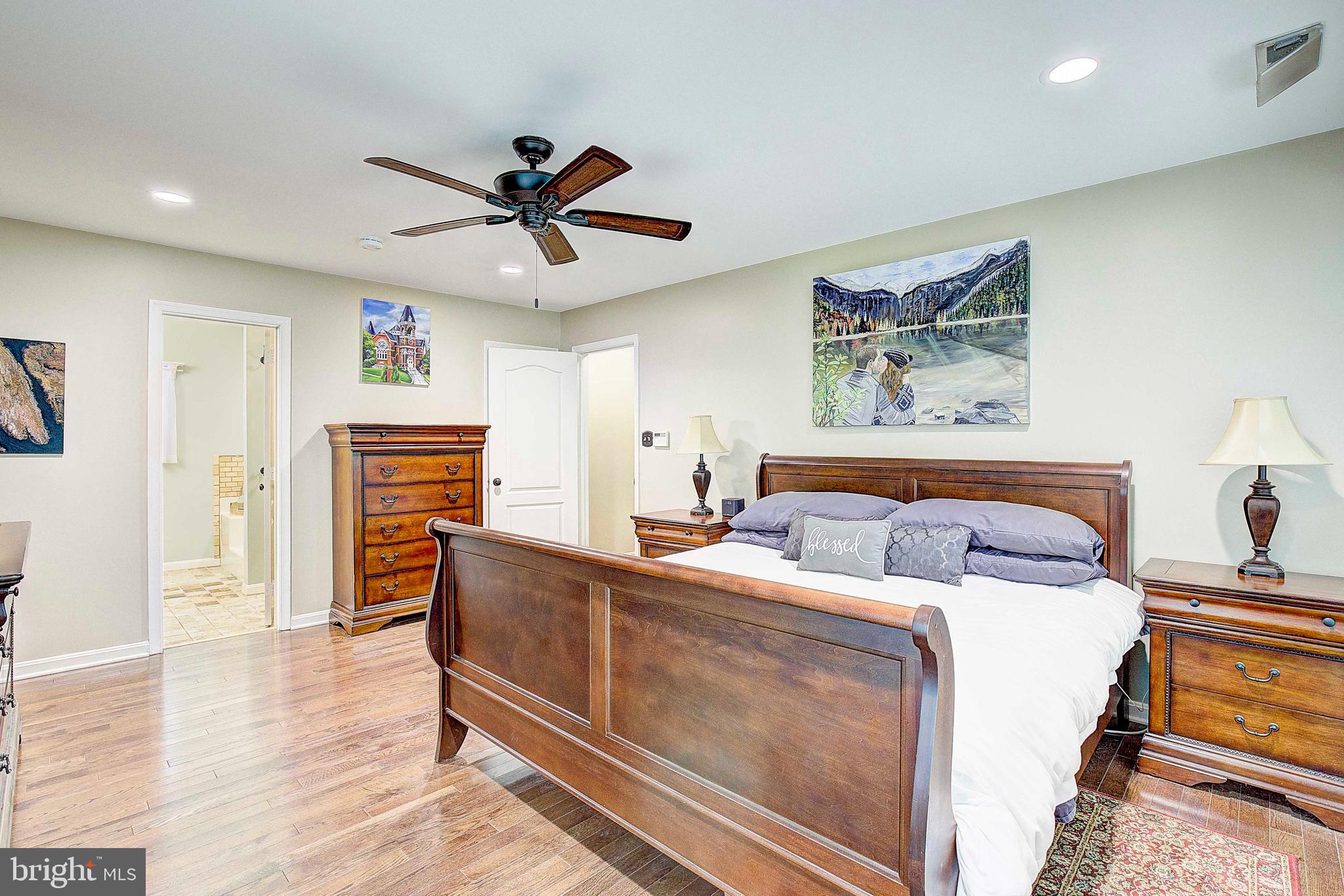 205 Walnut Creek Road Huntingtown, MD 20639 - Photo 38 of 48 a spacious bedroom with a bed and a chandelier