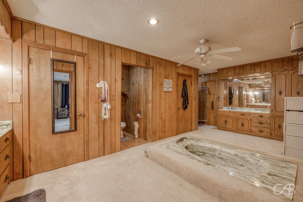 33 Northwest Ave A Hamlin, TX 79520 - Photo 15 of 37 a bedroom with a bed and a large mirror