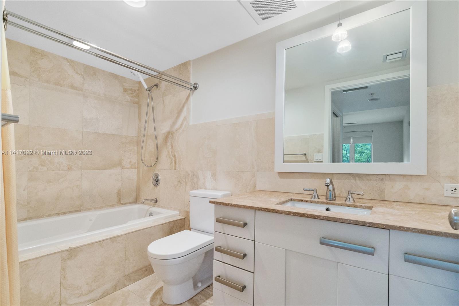 3540 Main Highway, Unit 309 Miami, FL 33133 - Photo 17 of 34 a bathroom with a sink toilet vanity and shower