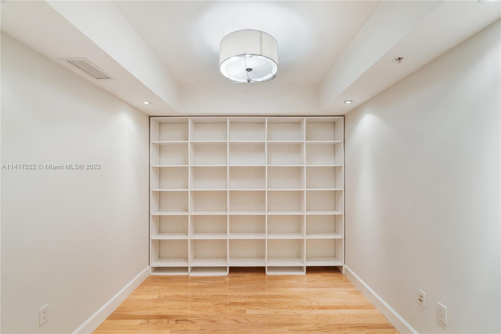 3540 Main Highway, Unit 309 Miami, FL 33133 - Photo 10 of 34 a view of an empty room with a window and wooden floor