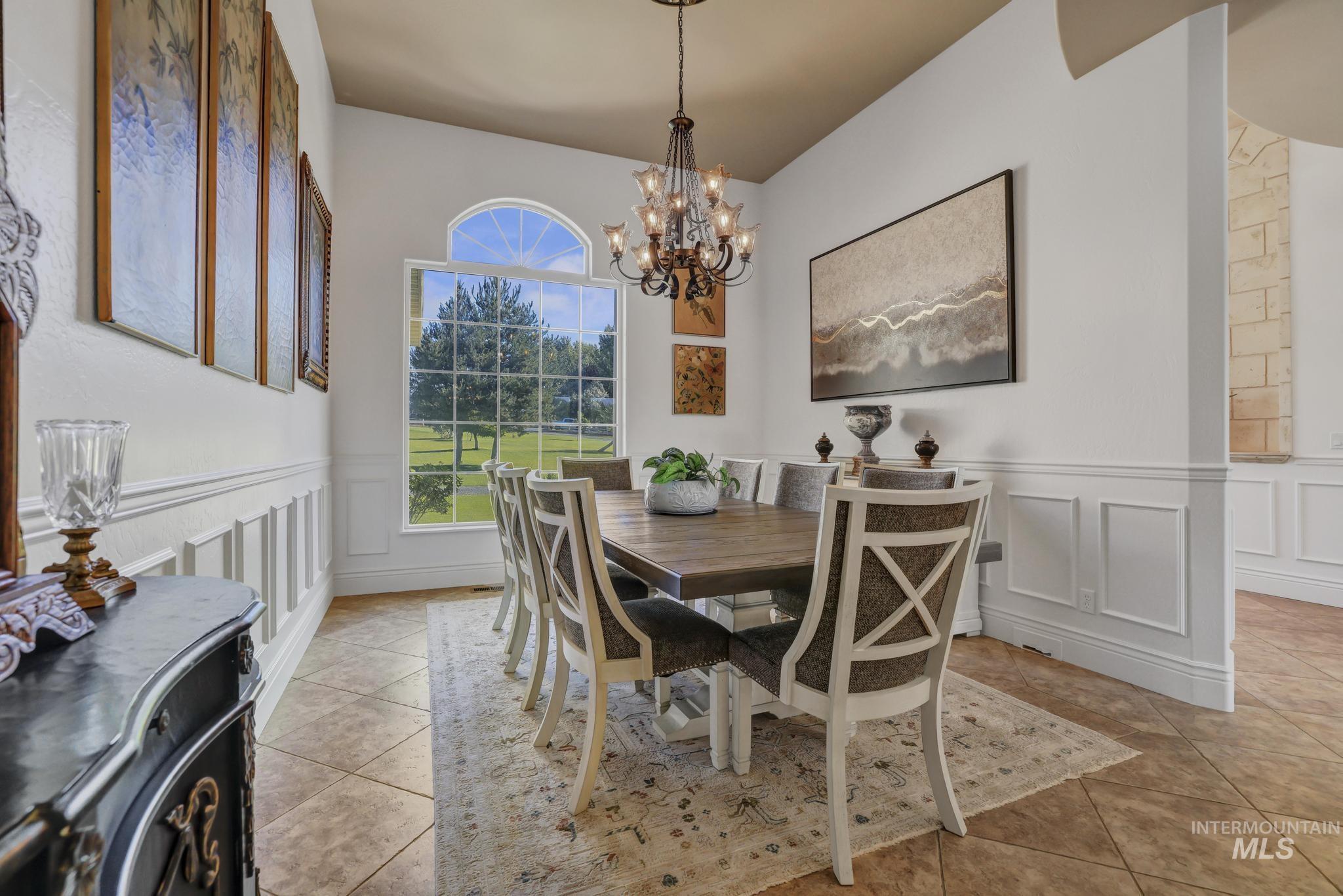 1301 Kanaka Rapids Road Buhl, ID 83316 - Photo 10 of 50 Formal dining area featuring a prominent arched window overlooking green space