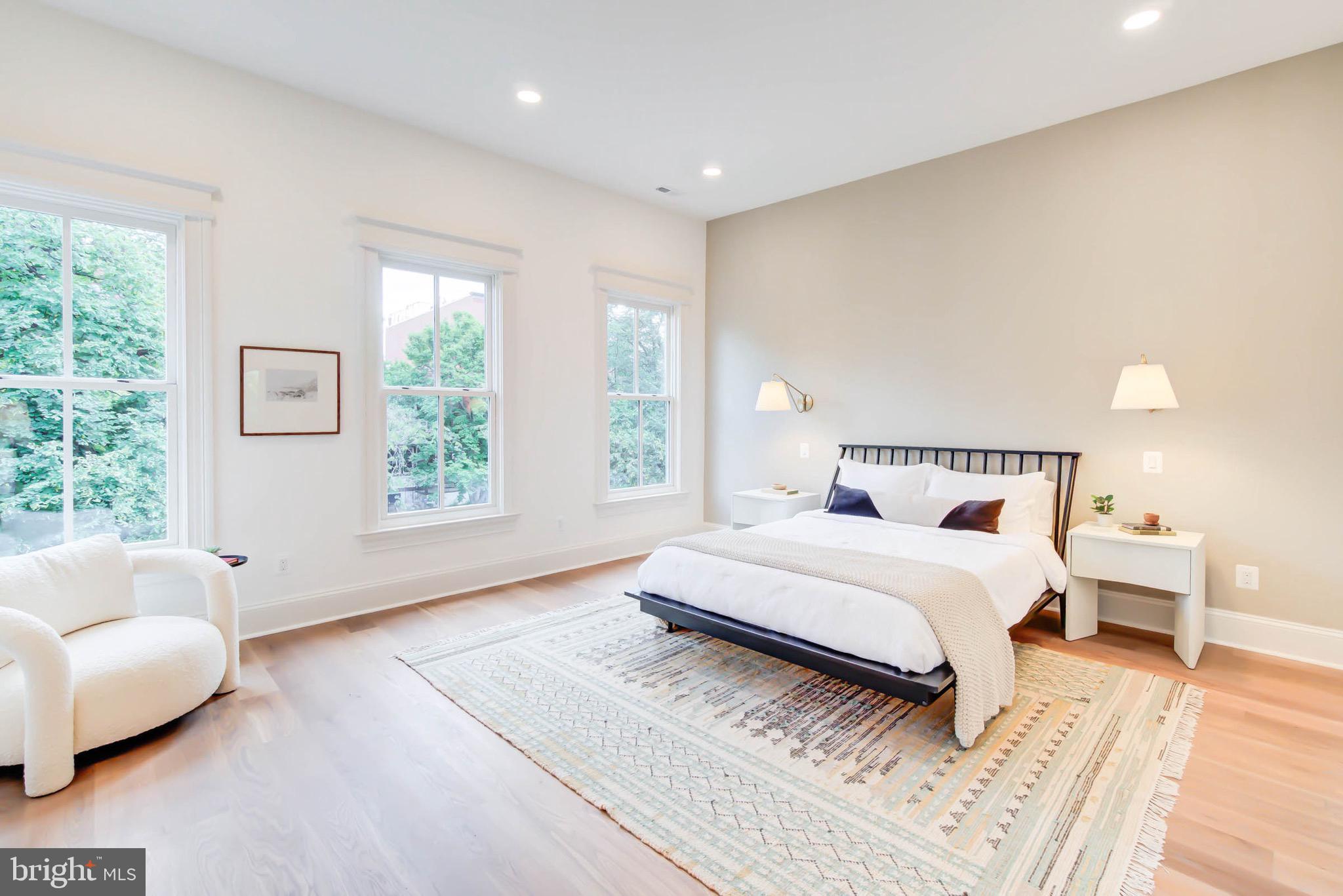 311 5th Street Southeast Washington, DC 20003 - Photo 14 of 21 a spacious bedroom with a bed and a couch
