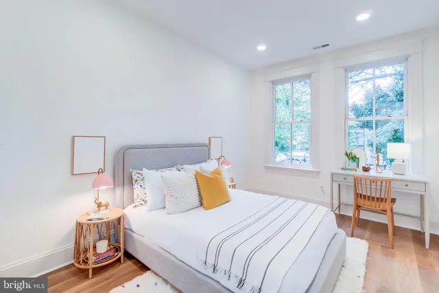 a bedroom with a bed and a table