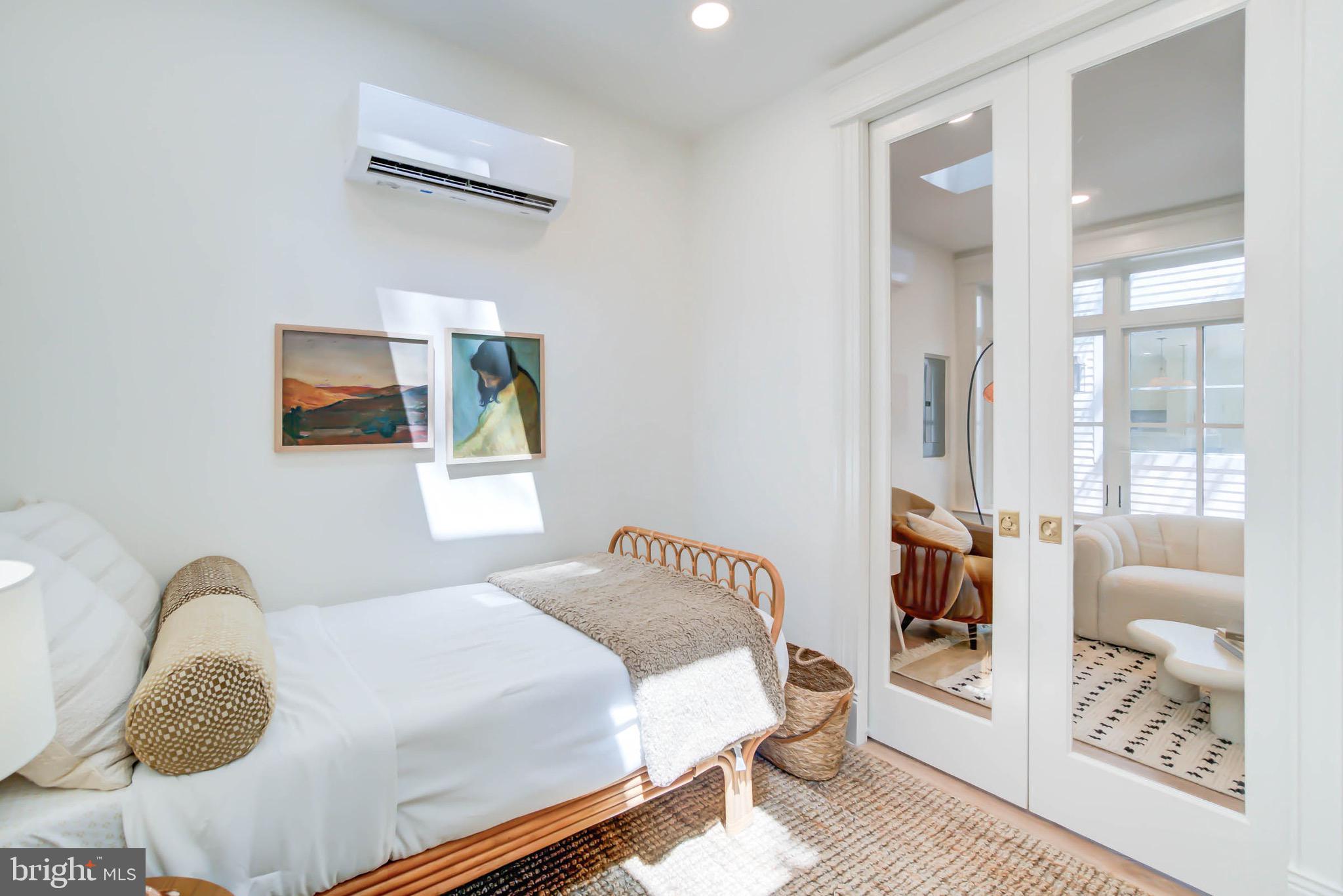 311 5th Street Southeast Washington, DC 20003 - Photo 21 of 21 a bedroom with a bed and a painting on the wall