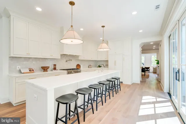 a large kitchen with lots of counter space wooden floor and appliances