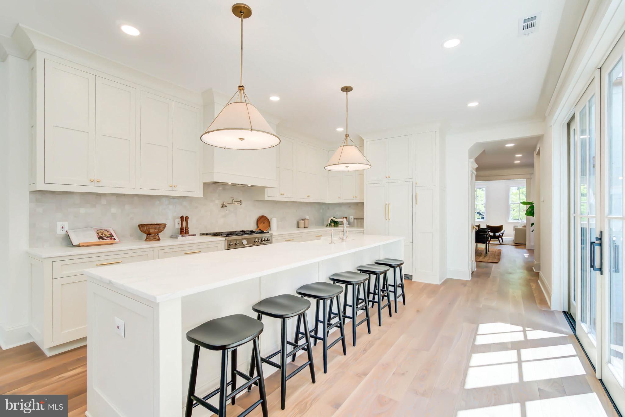 311 5th Street Southeast Washington, DC 20003 - Photo 10 of 21 a large kitchen with lots of counter space wooden floor and appliances