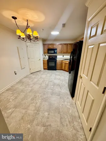 a view of a kitchen with refrigerator and microwave