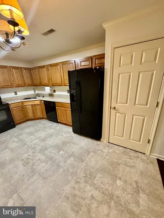 a kitchen with a stove a sink and a microwave