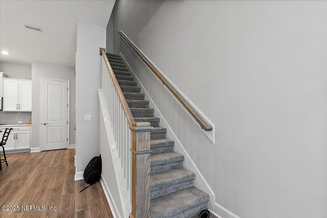 a view of entryway and hall with wooden floor