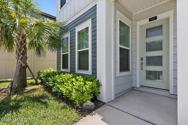 front view of a house with a potted plant
