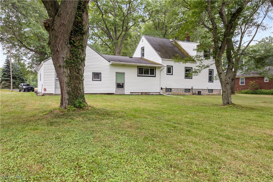 6266 Murray Ridge Road Elyria, OH 44035 - Photo 3 of 36 Rear view of house featuring a lawn