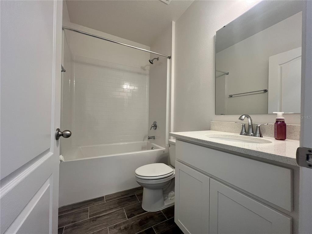 301 Jackson Loop DeLand, FL 32724 - Photo 15 of 22 a bathroom with a sink toilet vanity and shower
