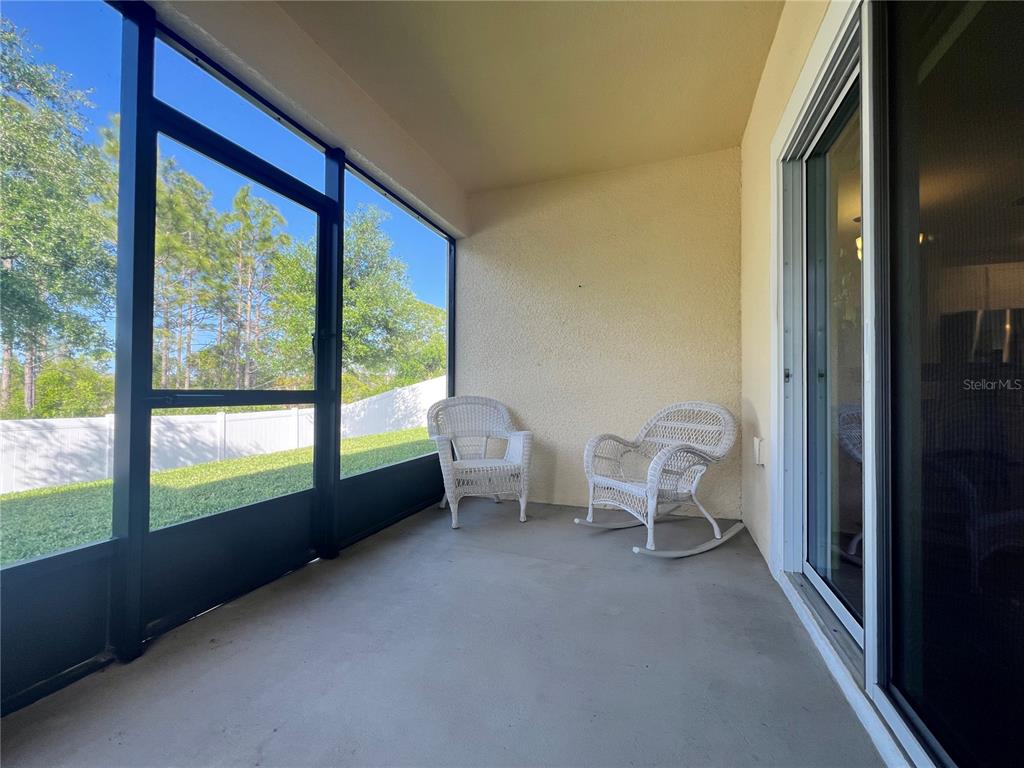 301 Jackson Loop DeLand, FL 32724 - Photo 21 of 22 a living room with furniture and a floor to ceiling window