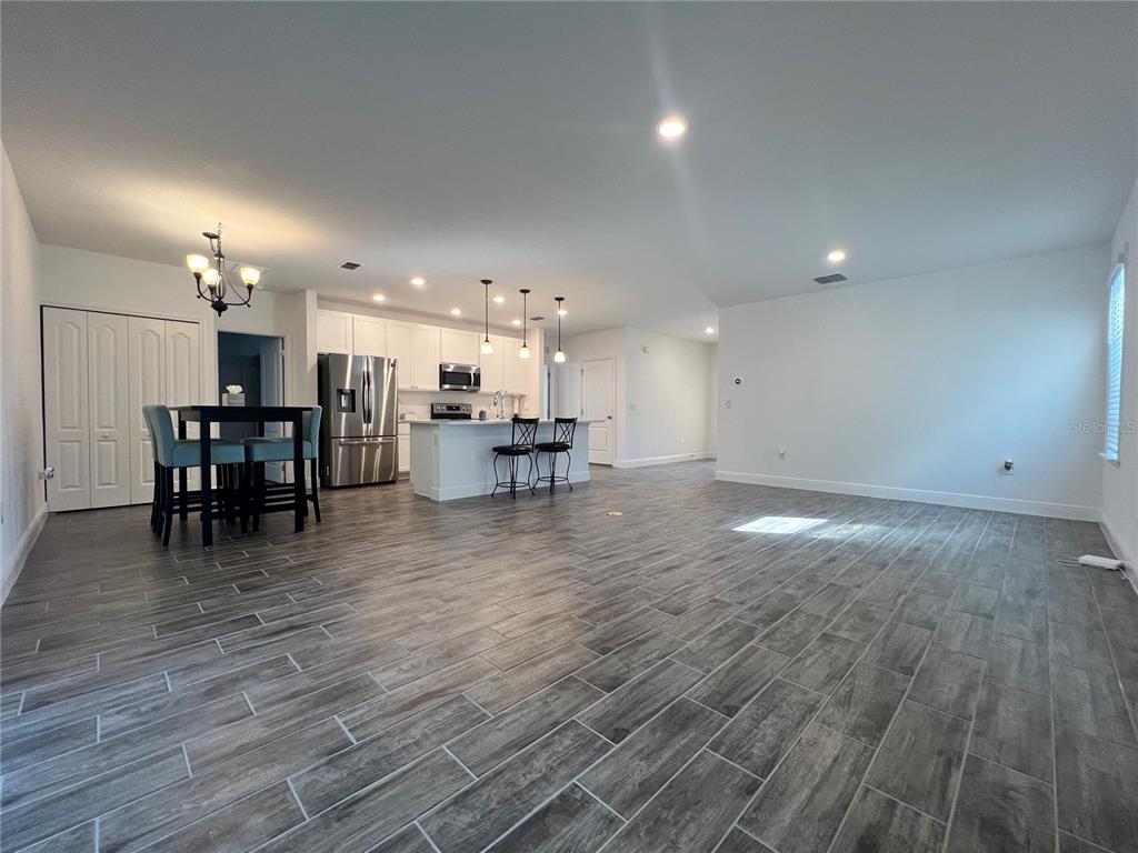 301 Jackson Loop DeLand, FL 32724 - Photo 8 of 22 a view of a room with kitchen island hardwood floor and a sink