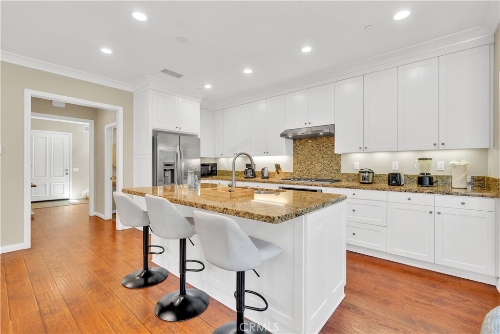 75 Gardenstone Path Irvine, CA 92620 - Photo 14 of 65 a kitchen with stainless steel appliances granite countertop a sink and cabinets
