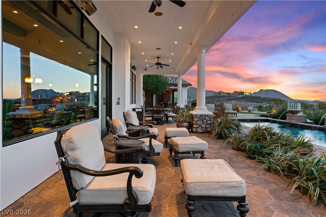 1123 Christian Road Henderson, NV 89002 - Photo 73 of 94 An inviting covered patio with a flagstone floor overlooks a tranquil pool and breathtaking mountain vistas.