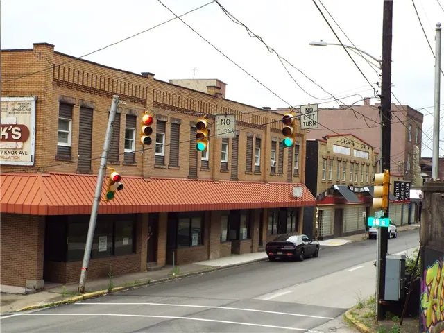 a view of a building with car parked