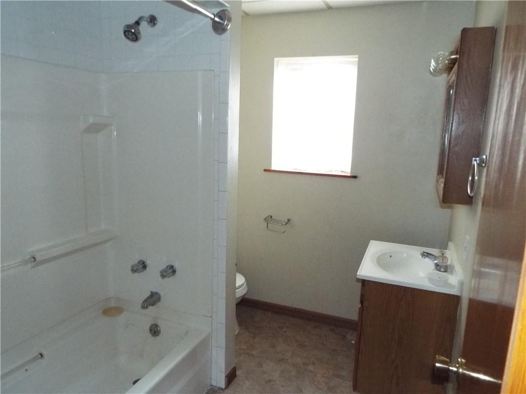 559 Schoonmaker Avenue Monessen, PA 15062 - Photo 15 of 50 a bathroom with a bathtub sink and vanity