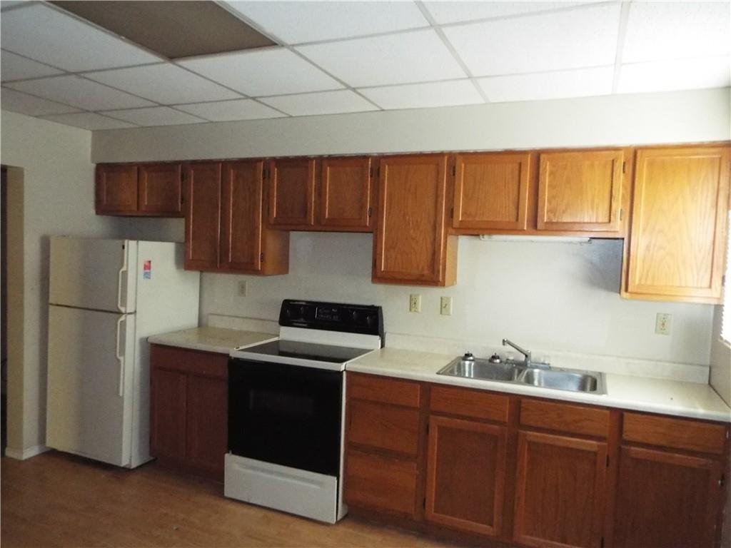 559 Schoonmaker Avenue Monessen, PA 15062 - Photo 28 of 50 a kitchen with a sink a refrigerator and cabinets
