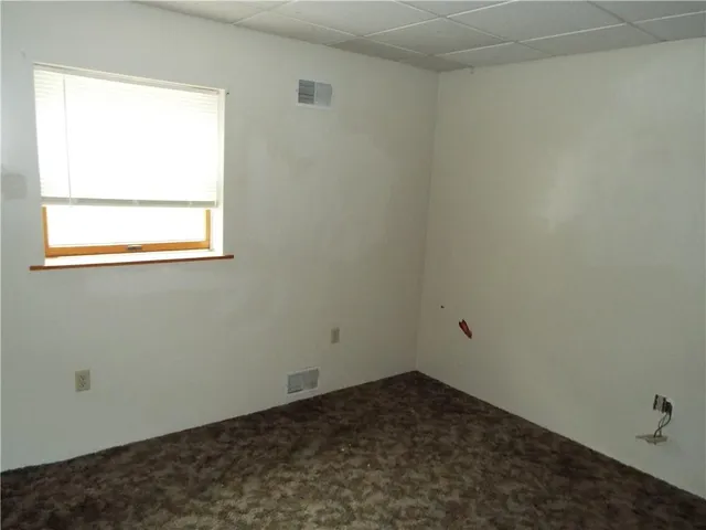 a kitchen with cabinets and refrigerator