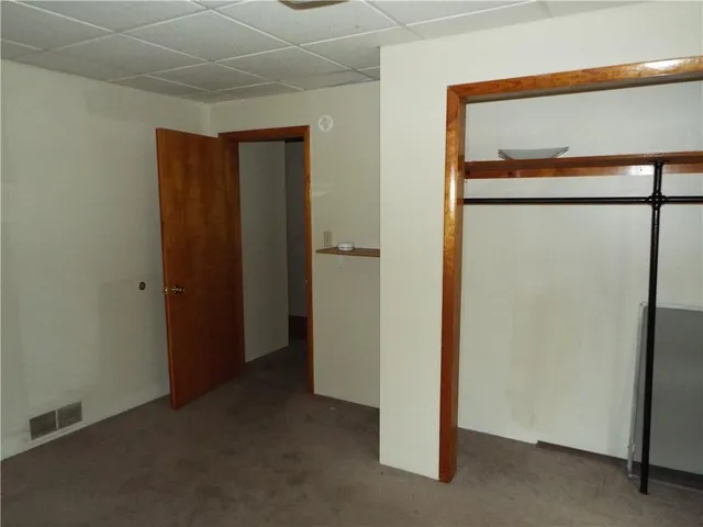 a view of a room with drop ceiling