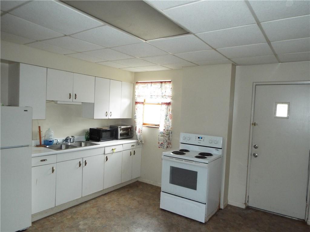 559 Schoonmaker Avenue Monessen, PA 15062 - Photo 41 of 50 a kitchen with white cabinets appliances and a sink