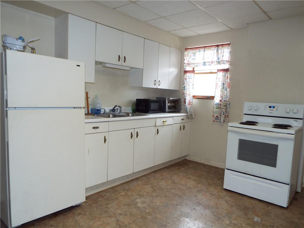 559 Schoonmaker Avenue Monessen, PA 15062 - Photo 49 of 50 a kitchen with cabinets appliances a sink and a window