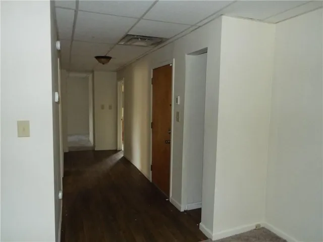 a view of hallway with wooden floor