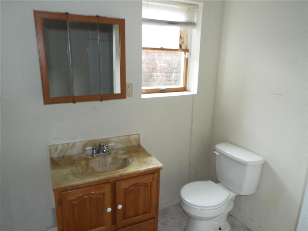 559 Schoonmaker Avenue Monessen, PA 15062 - Photo 10 of 50 a bathroom with a toilet sink and mirror