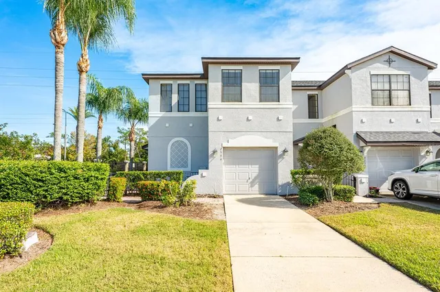 a view of a house with pool plants and palm trees