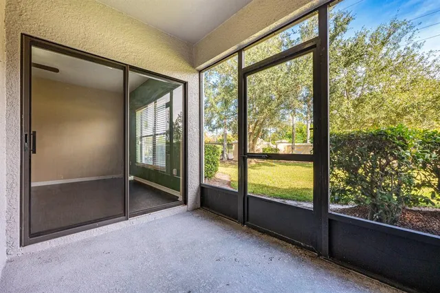 an empty room with sliding glass door and mountain view