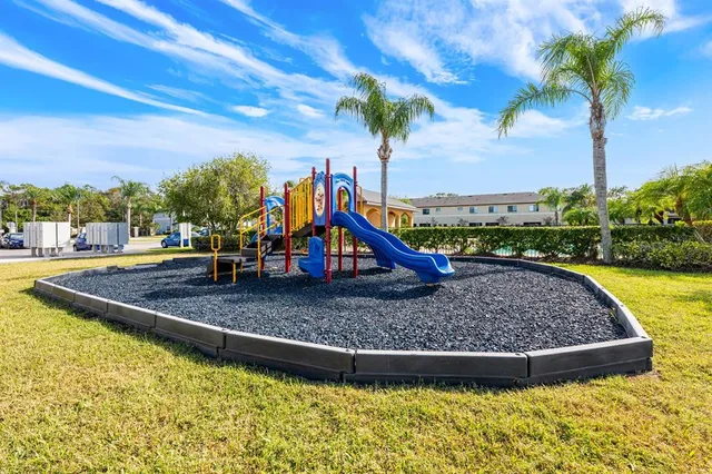 a front view of a house with garage and plants