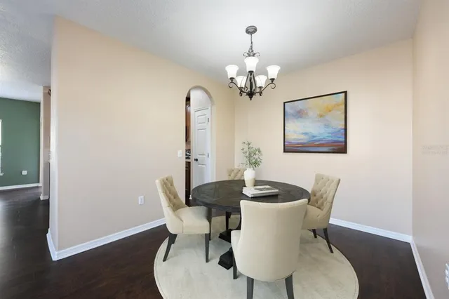 a view of a dining room with furniture and wooden floor