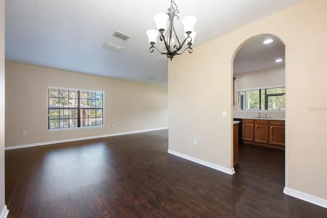 a view of a room with wooden floor and windows