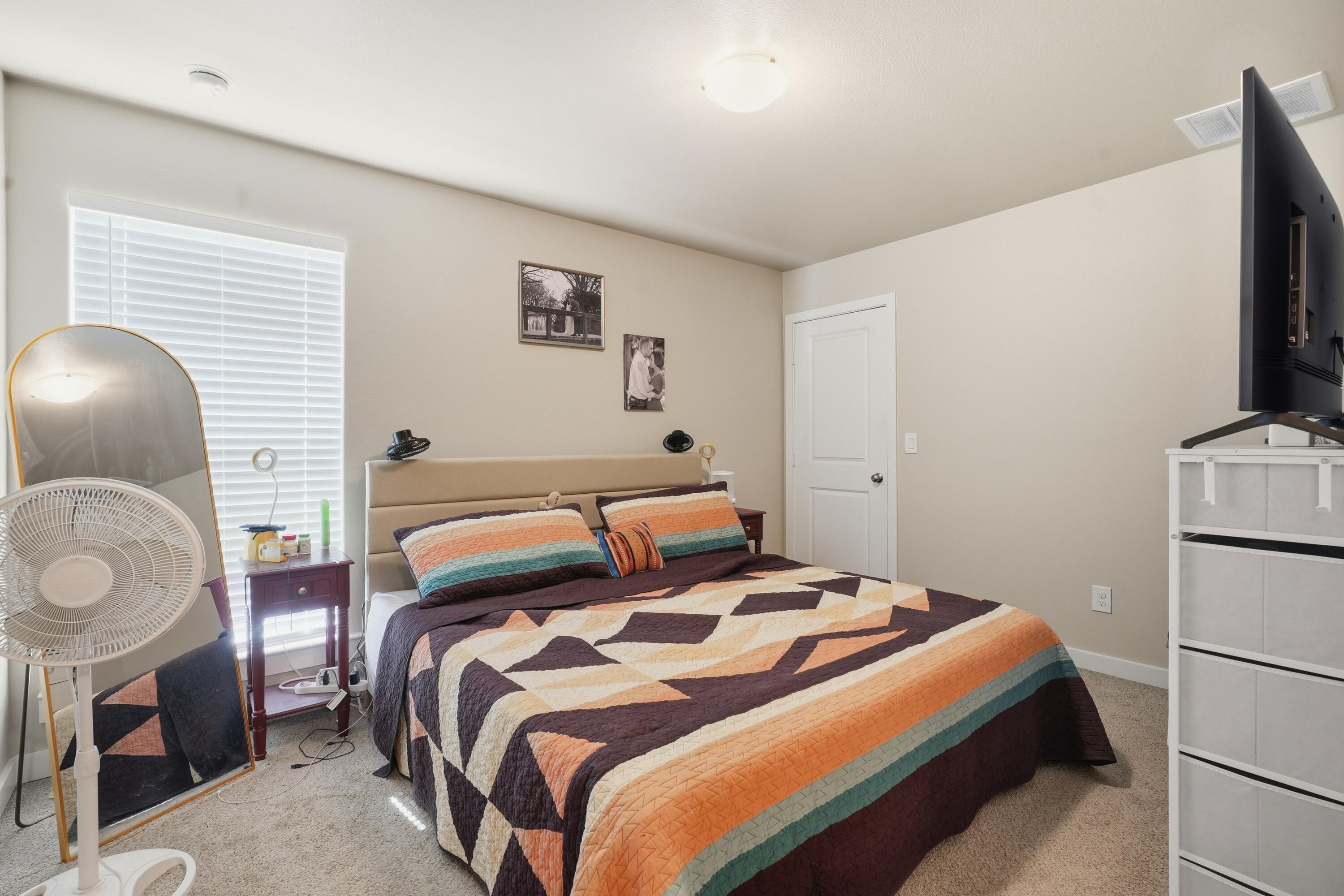 1605 135th Street Lubbock, TX 79423 - Photo 12 of 21 a bedroom with a bed and a flat screen tv