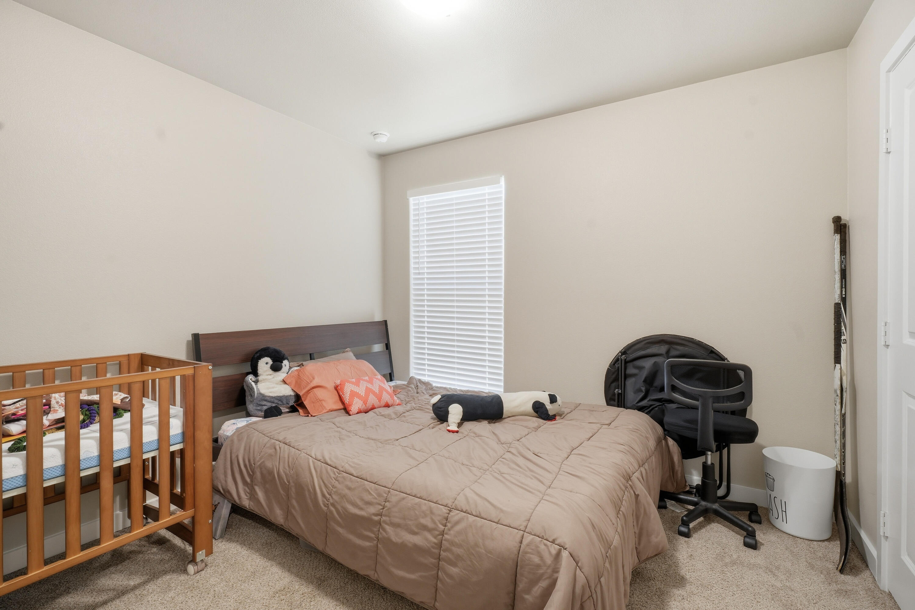 1605 135th Street Lubbock, TX 79423 - Photo 17 of 21 a bedroom with a bed a window and chair