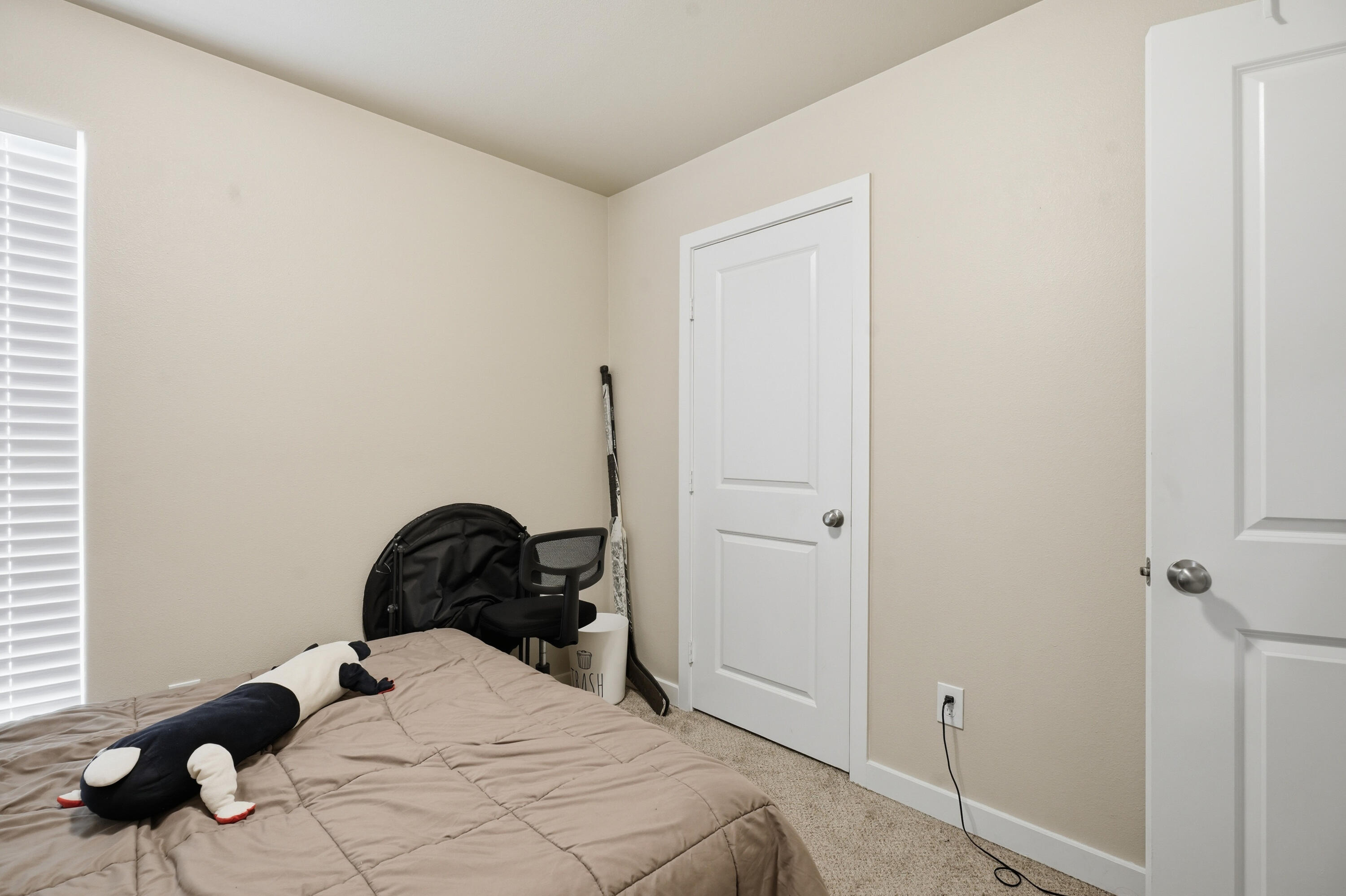 1605 135th Street Lubbock, TX 79423 - Photo 18 of 21 a bedroom with a bed and a dresser