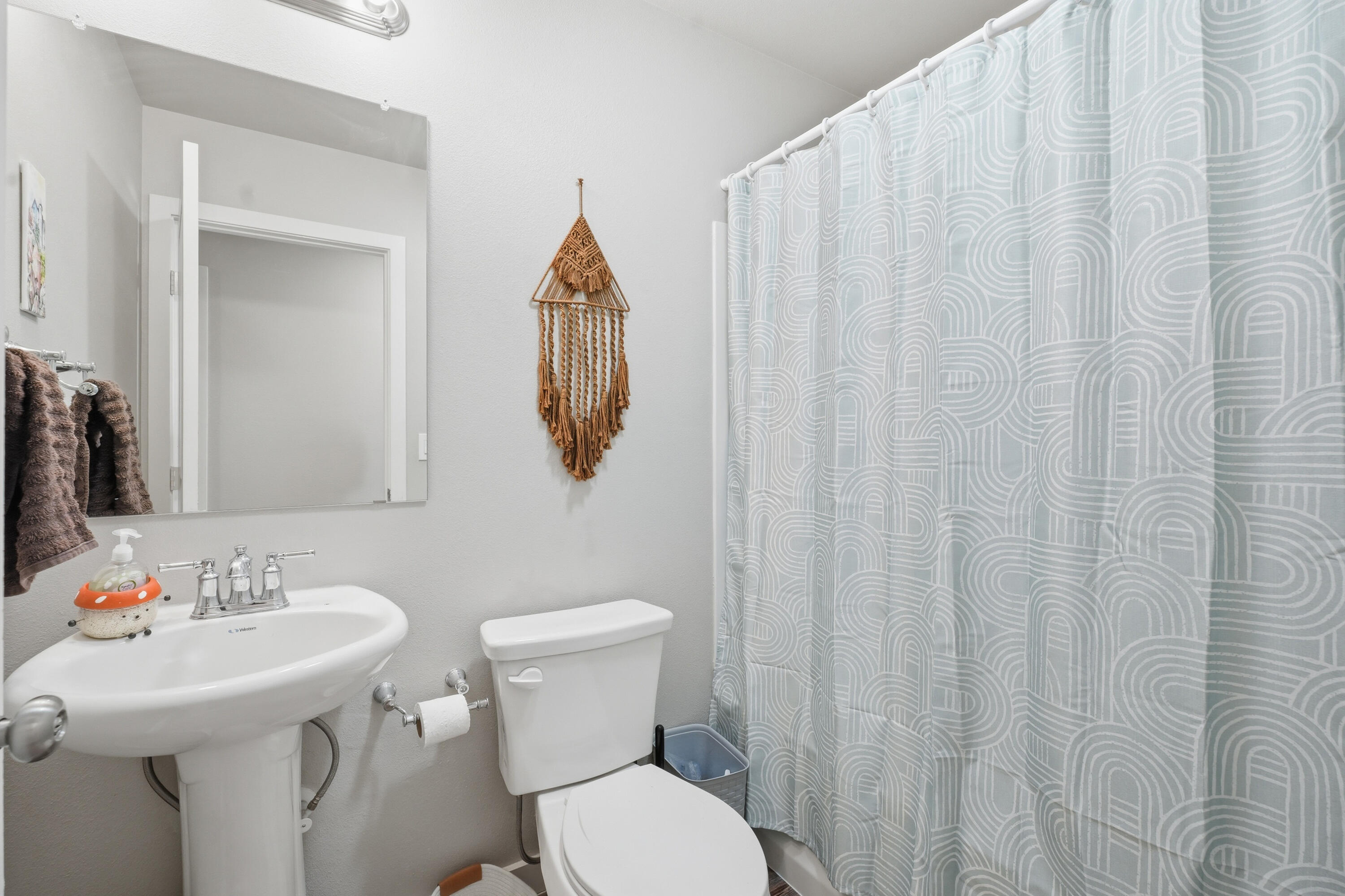 1605 135th Street Lubbock, TX 79423 - Photo 19 of 21 a bathroom with a sink a toilet and a mirror