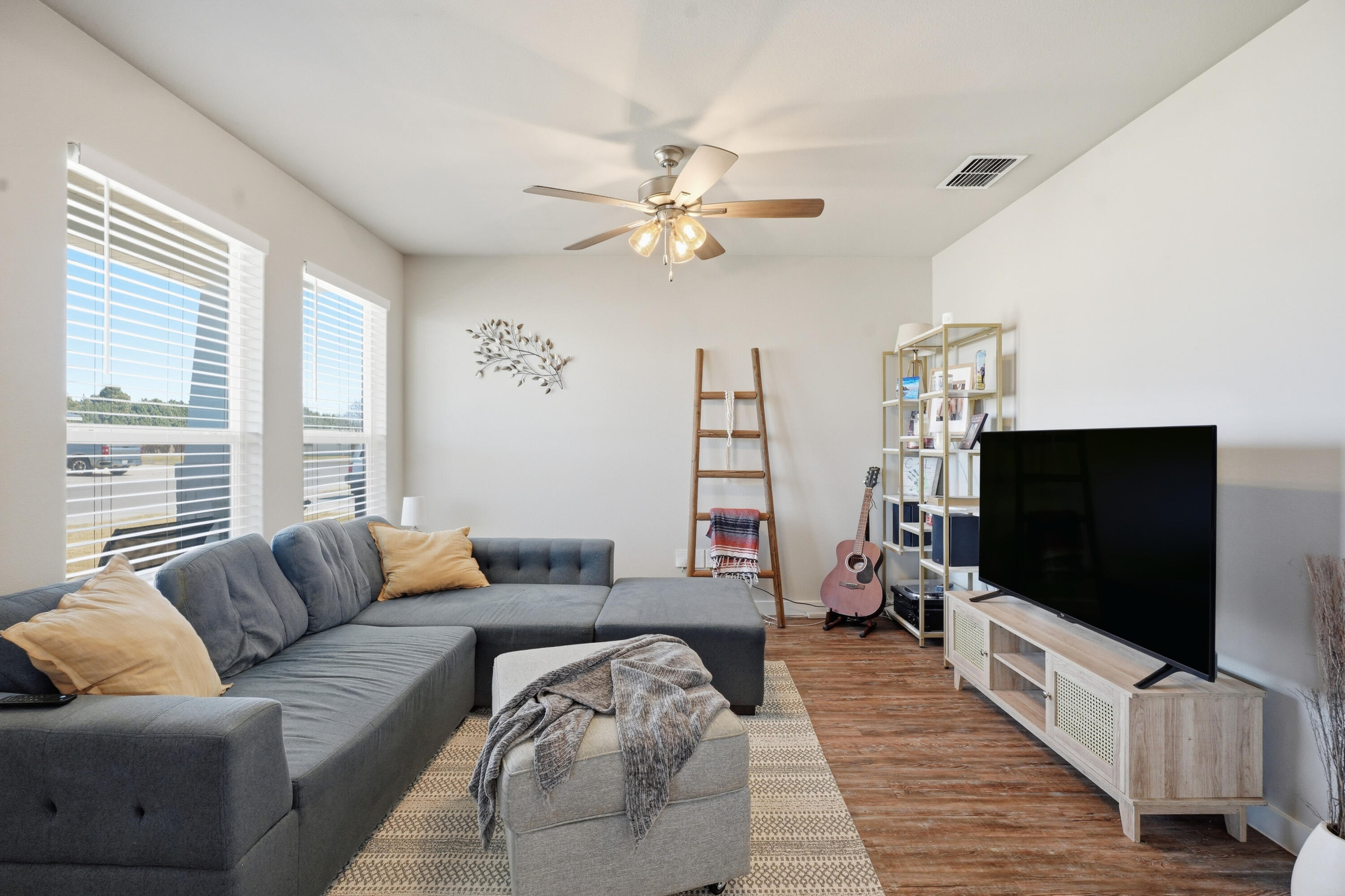 1605 135th Street Lubbock, TX 79423 - Photo 2 of 21 a living room with furniture and a flat screen tv