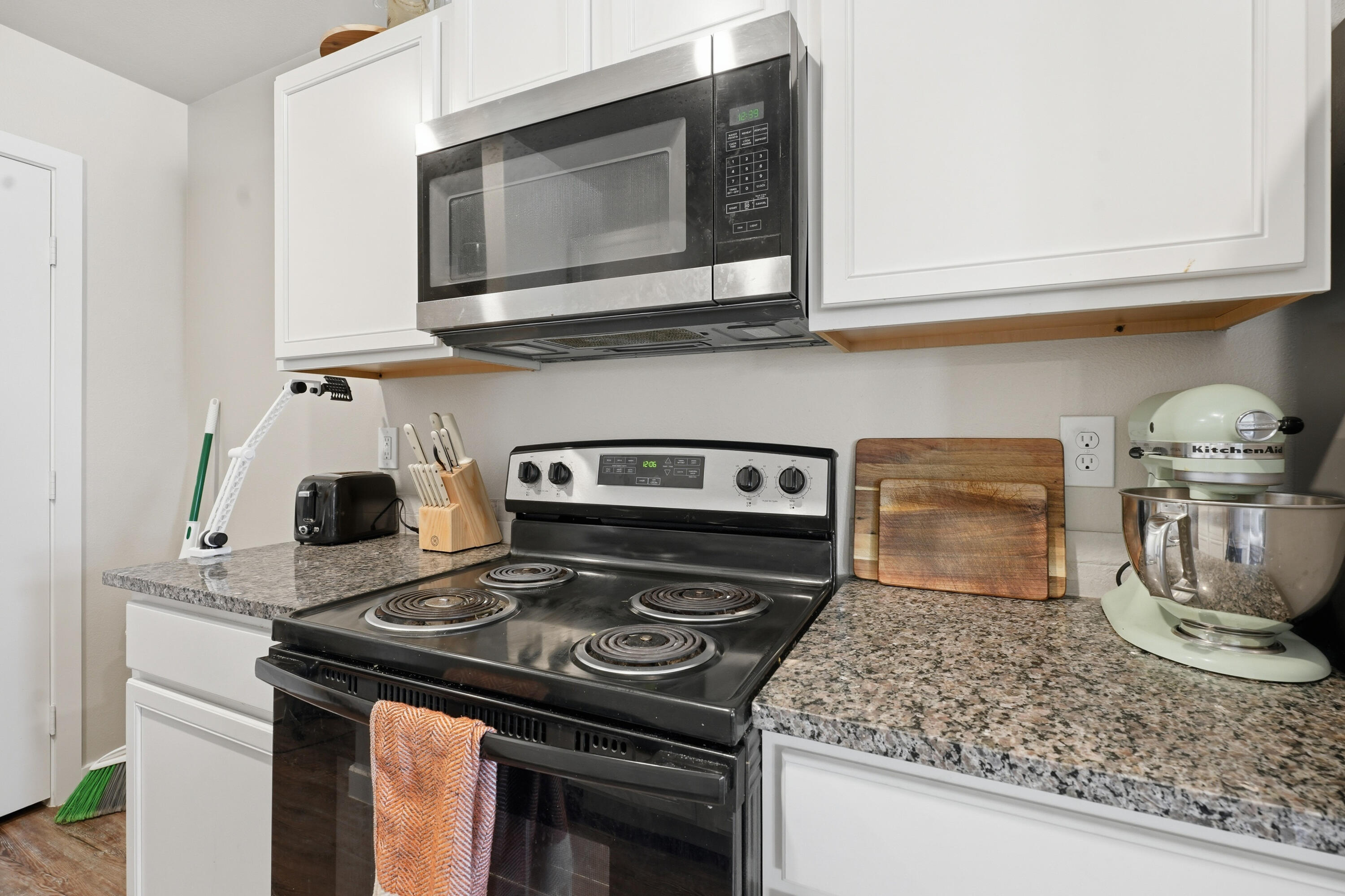 1605 135th Street Lubbock, TX 79423 - Photo 9 of 21 a kitchen with a stove and a microwave