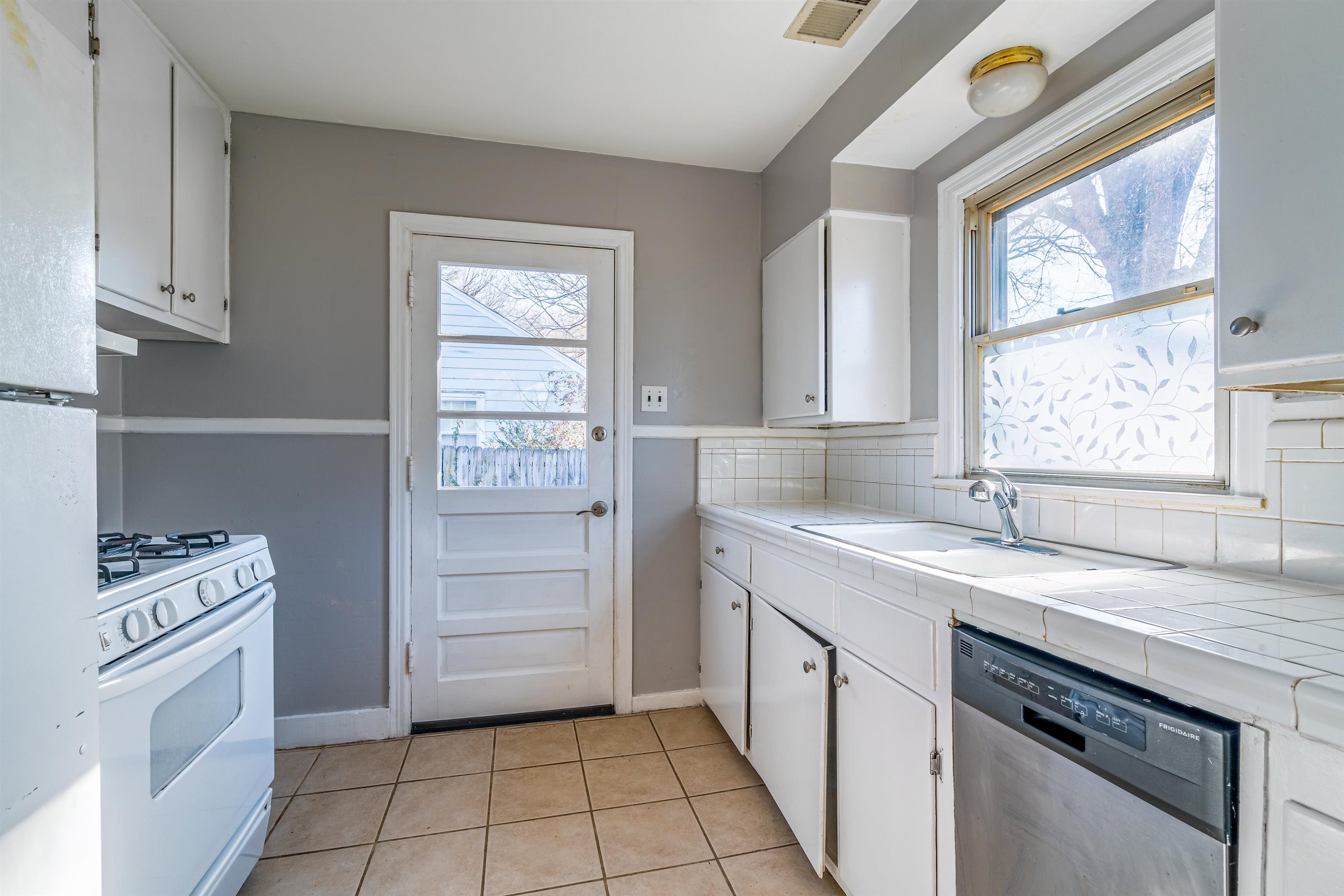 4430 Boyce Road Memphis, TN 38117 - Photo 11 of 25 a kitchen with a stove cabinets and a sink
