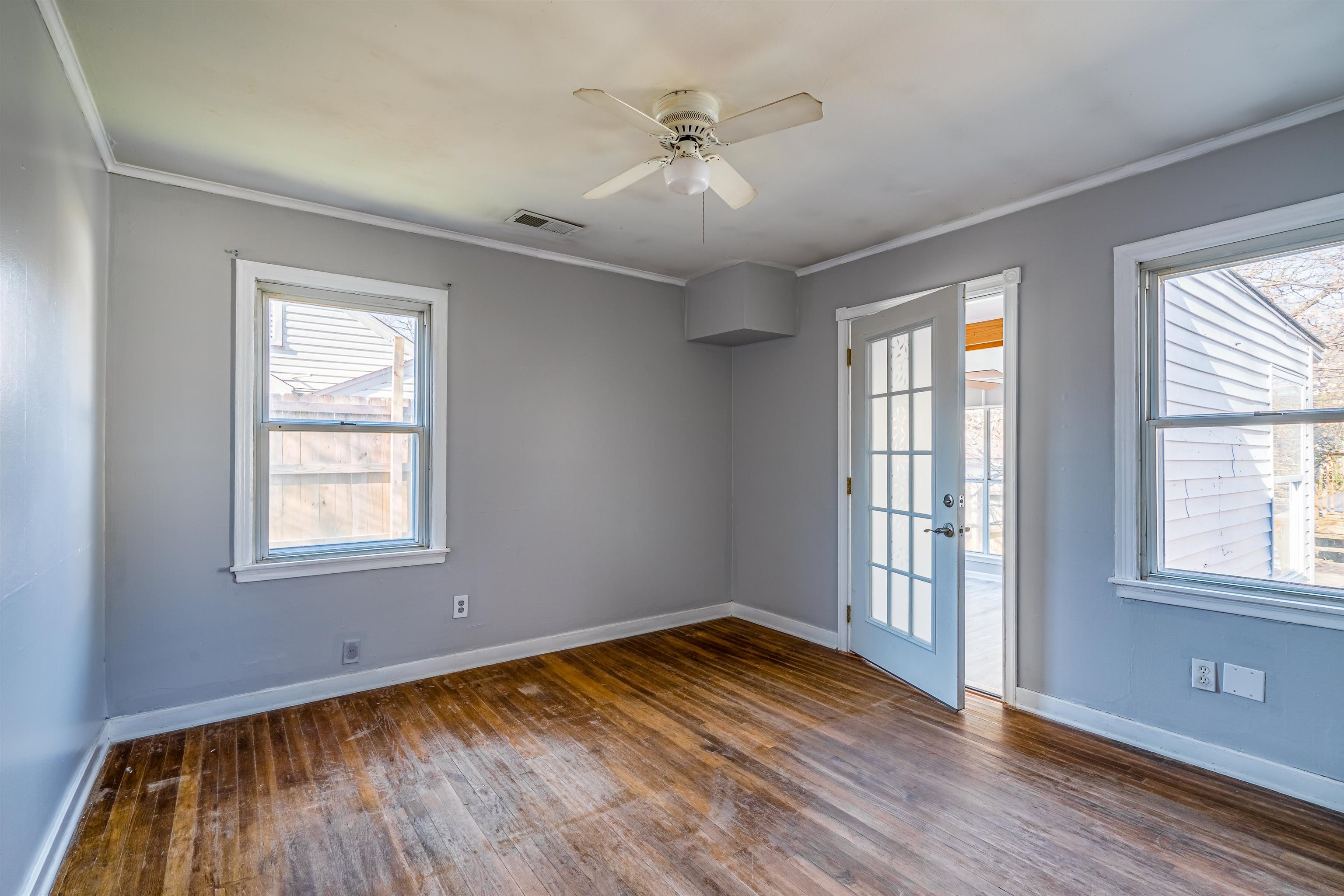 4430 Boyce Road Memphis, TN 38117 - Photo 14 of 25 an empty room with wooden floor and windows