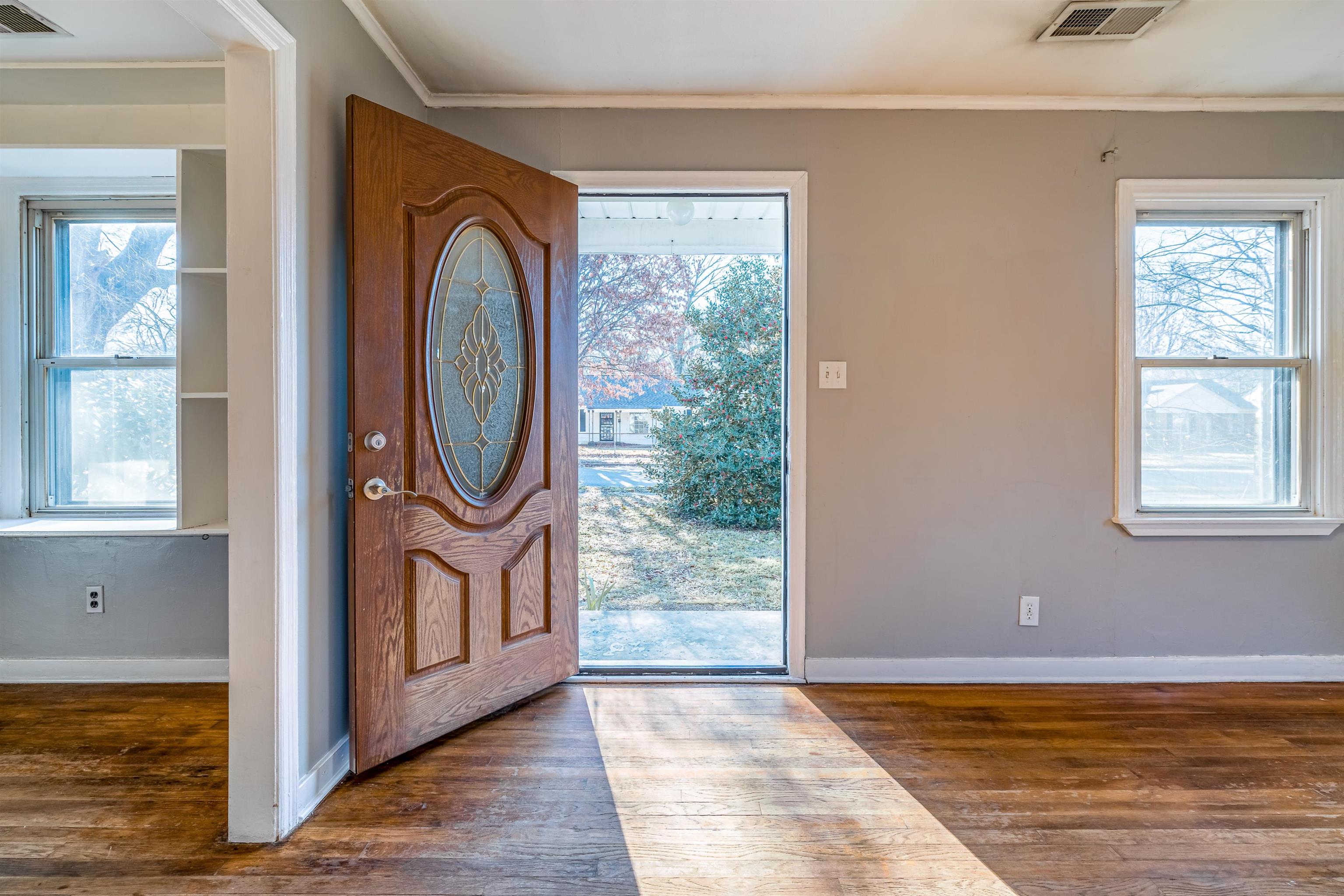 4430 Boyce Road Memphis, TN 38117 - Photo 5 of 25 a view of empty room with window and wooden floor