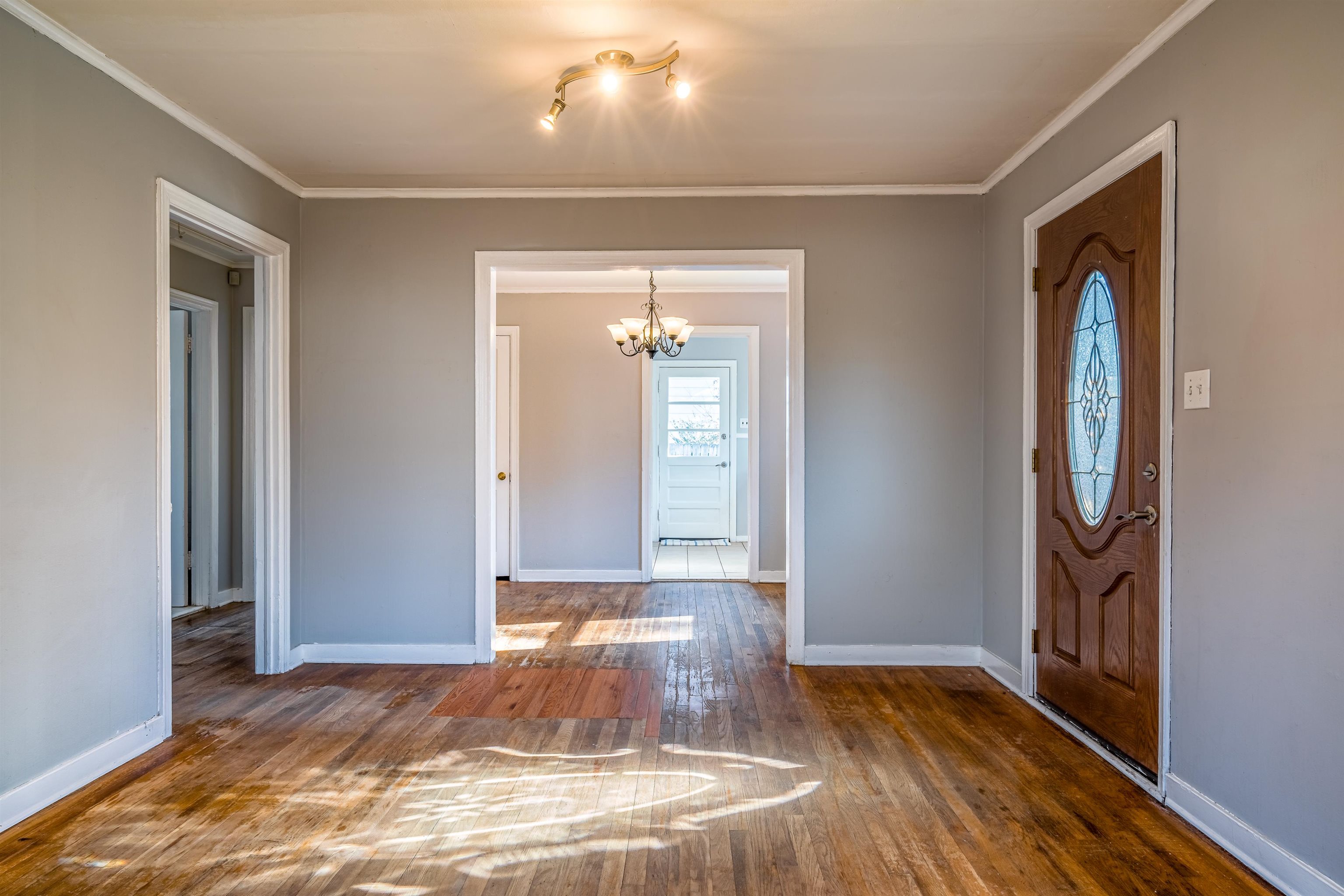 4430 Boyce Road Memphis, TN 38117 - Photo 7 of 25 an empty room with wooden floor and mirror
