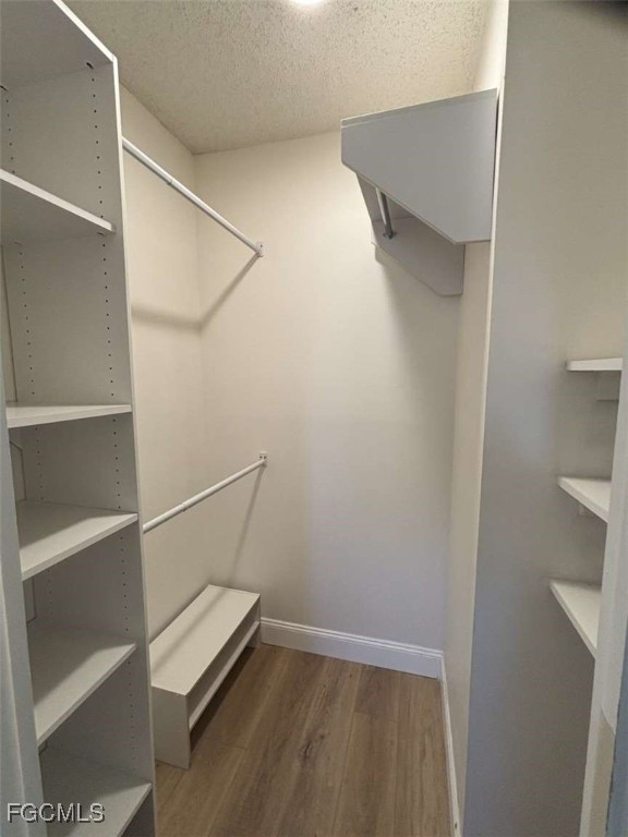 180 Turtle Lake Court, Unit 101 Naples, FL 34105 - Photo 12 of 14 a view of walk in closet with empty racks
