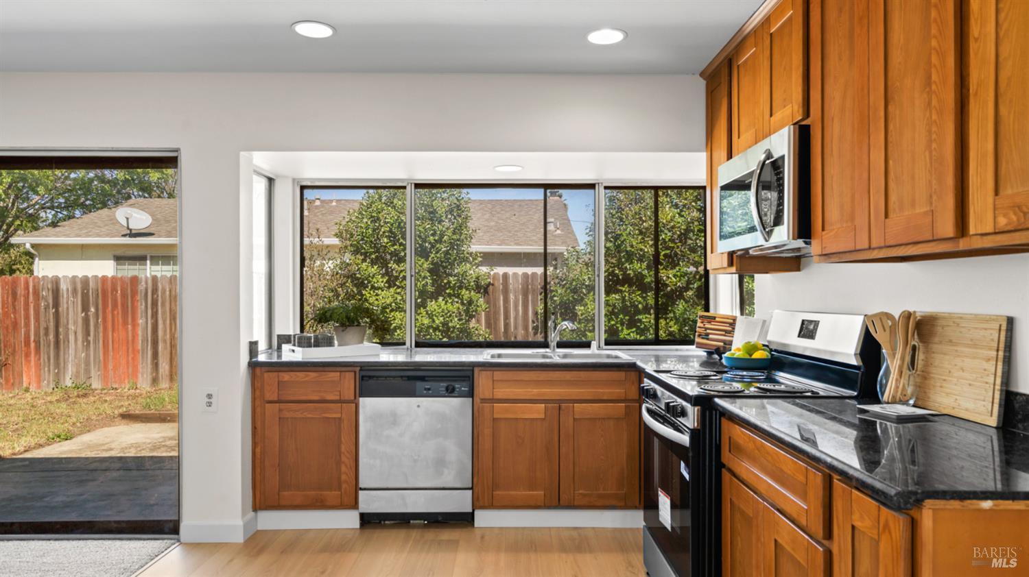 1312 Sutter Court Fairfield, CA 94533 - Photo 16 of 45 a kitchen with stainless steel appliances granite countertop a stove a sink and a microwave