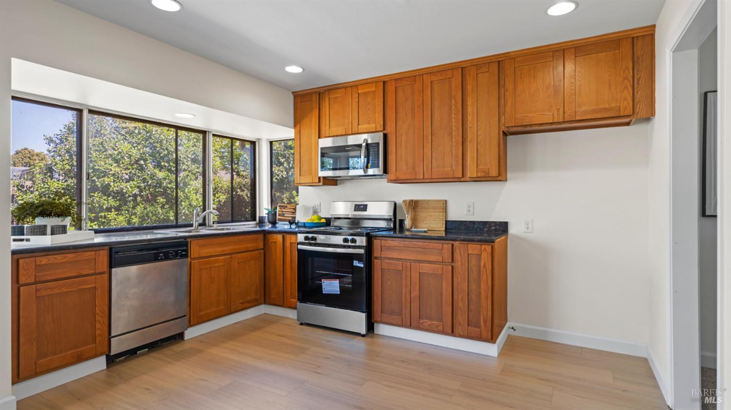 1312 Sutter Court Fairfield, CA 94533 - Photo 18 of 45 a kitchen with stainless steel appliances granite countertop wooden cabinets a stove a sink and dishwasher with wooden floor