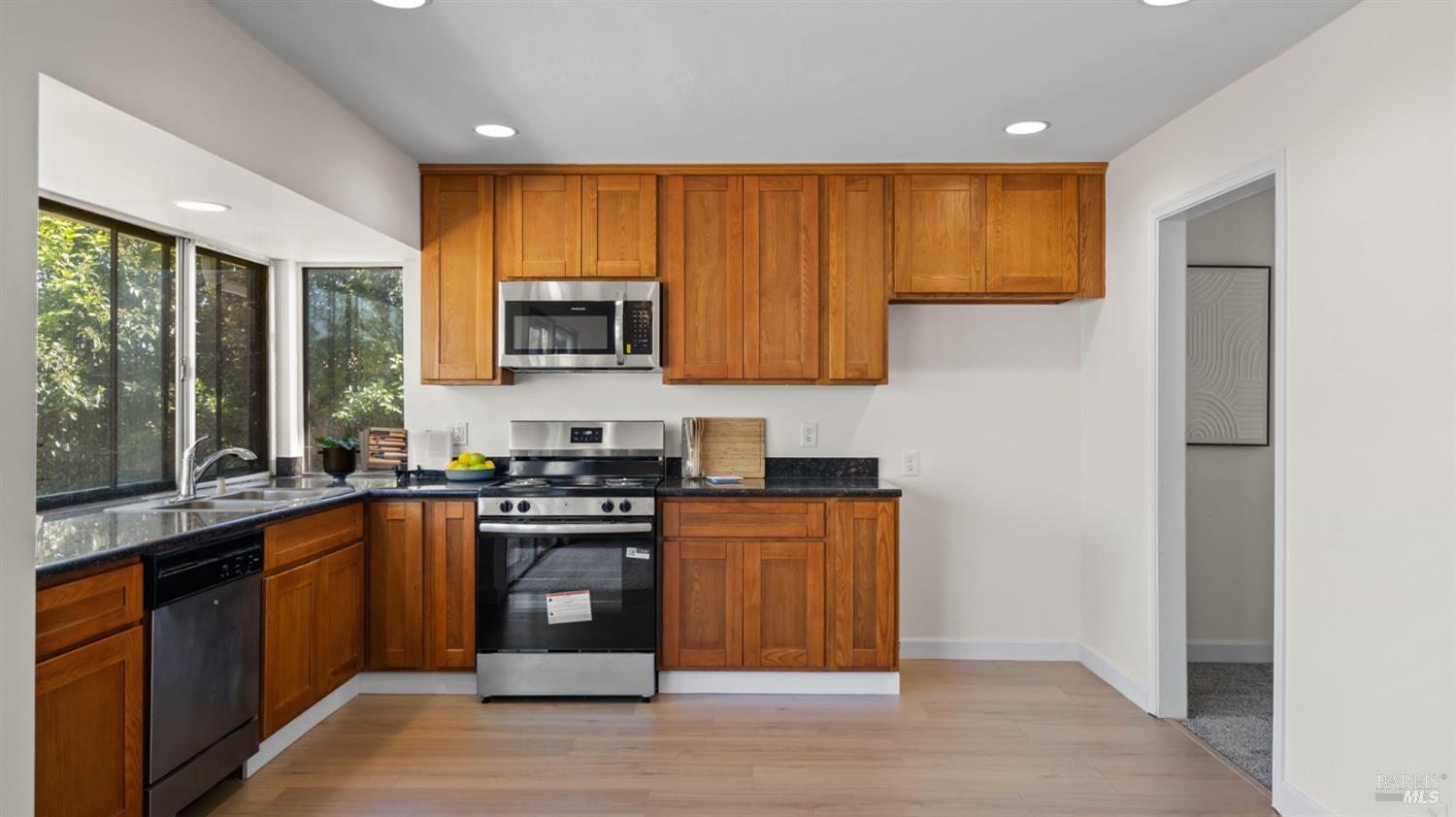 1312 Sutter Court Fairfield, CA 94533 - Photo 25 of 45 a kitchen with stainless steel appliances granite countertop wooden cabinets a sink a stove a refrigerator with grey cabinets and wooden floor