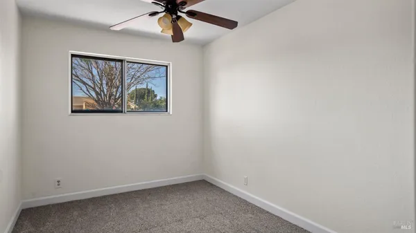 a large bed sitting in a bedroom next to a cabinet